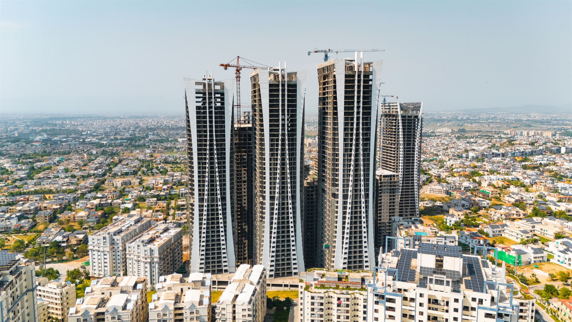 Aerial view of the Goldcrest Views towers within the Islamabad neighbourhood
